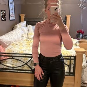 Pink turtleneck blouse